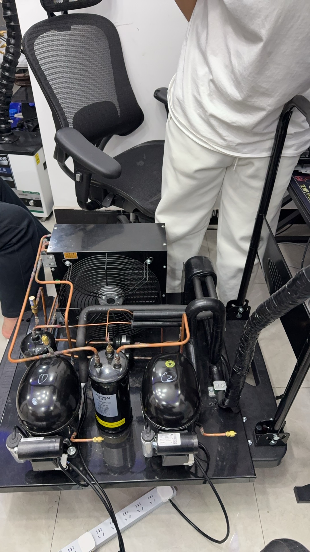Prototype cold head and insulated line connected to a desktop test system